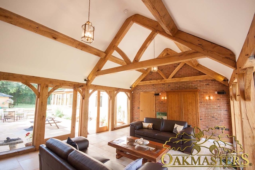 Glazed link-building used as sitting room with large glazed doors to garden