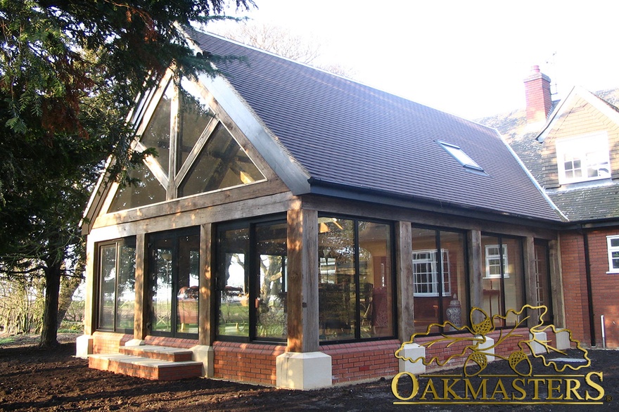 Sunroom with glazed gable and oak frame glazed walls linked to house