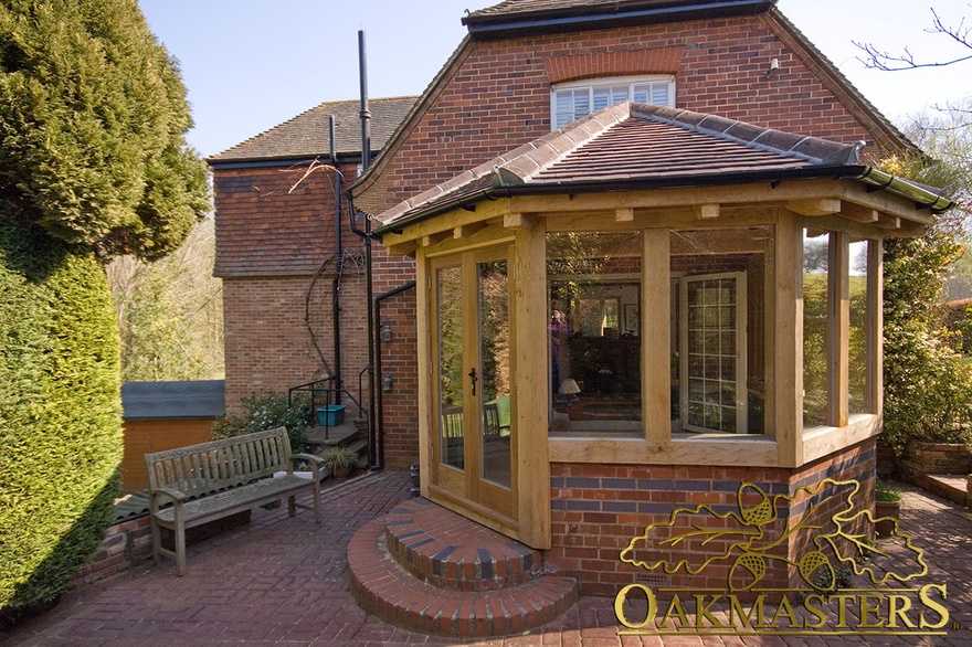 Hexagonal garden-room with part glazed walls and glazed door to patio