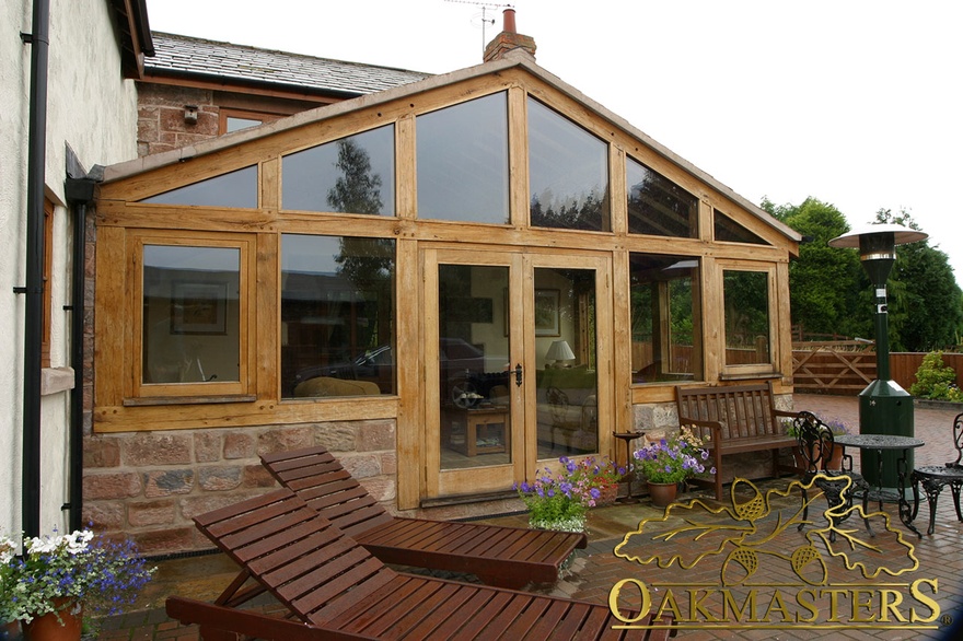 Oak and stone sun room with glazed gable