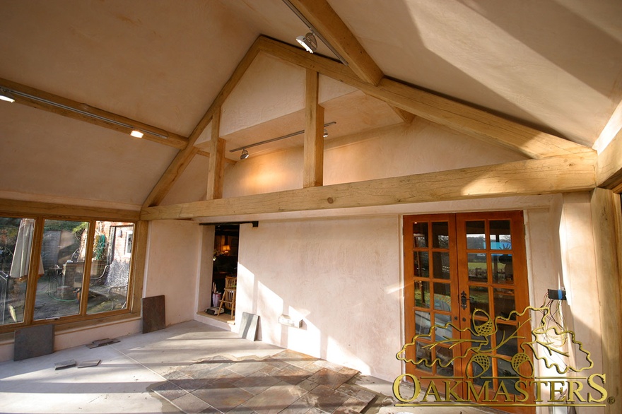 Interior of sunroom with modern glazing and exposed oak frame under construction