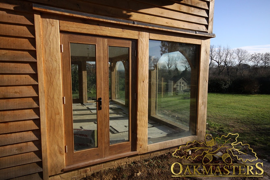 Oakframe glazed door and full height windows on outbuilding 