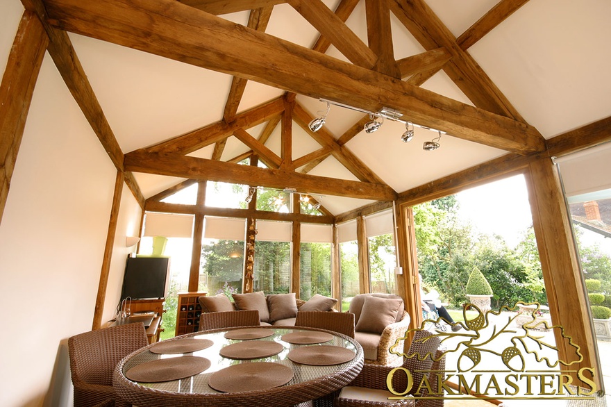 Exposed oak frame inside small glazed garden room