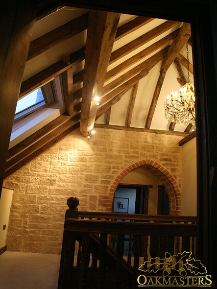View into the apex of the oak framed roof sitting on stone walls