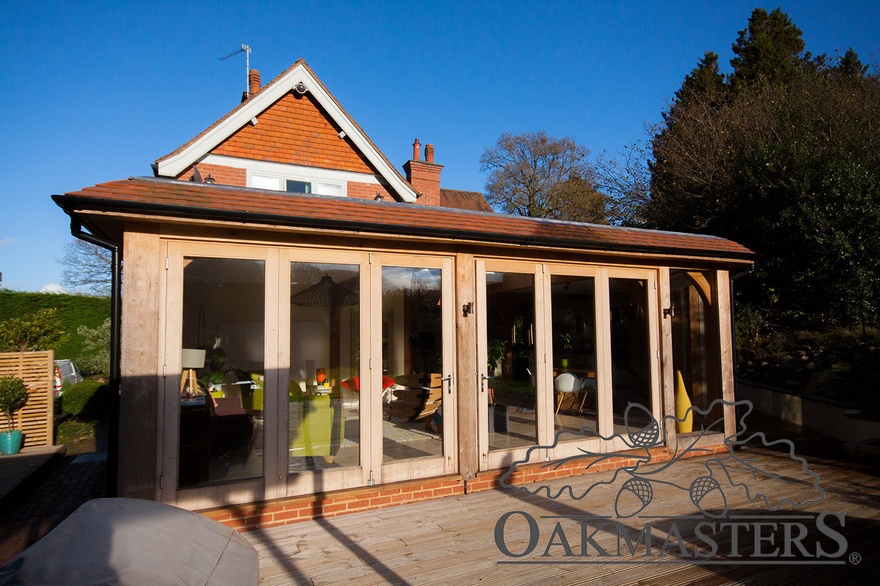 Hardwood bifold doors open up to a beautiful view of the garden