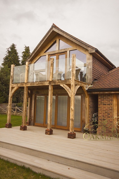 Detail of oak balcony with glass balustrade