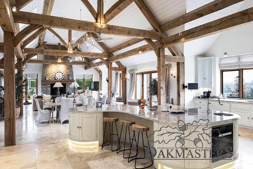 The oak frame with trusses, posts and beams sits inside the brick structure of the kitchen diner area