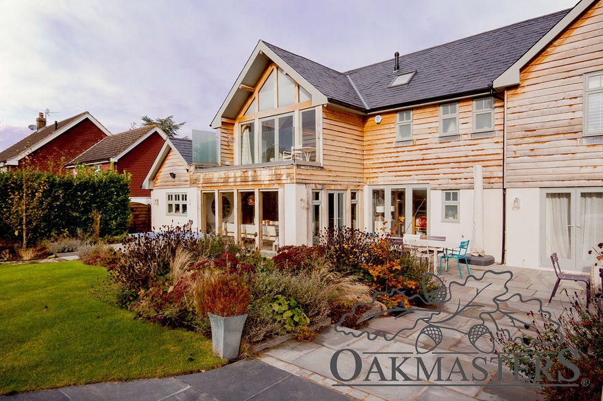 At the rear, the oak extension has been stepped back to create a small balcony