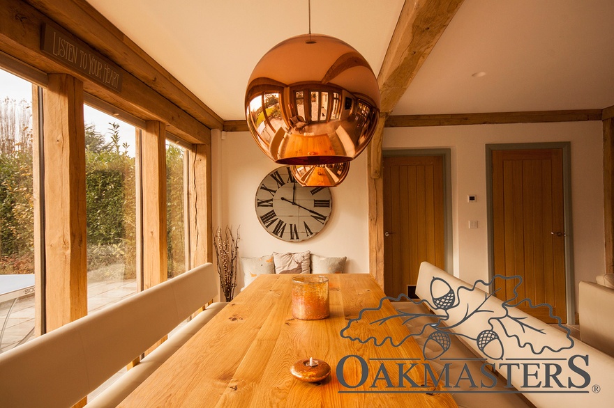 Exposed oak beams and oak joinery compete the character of the oak framed extension