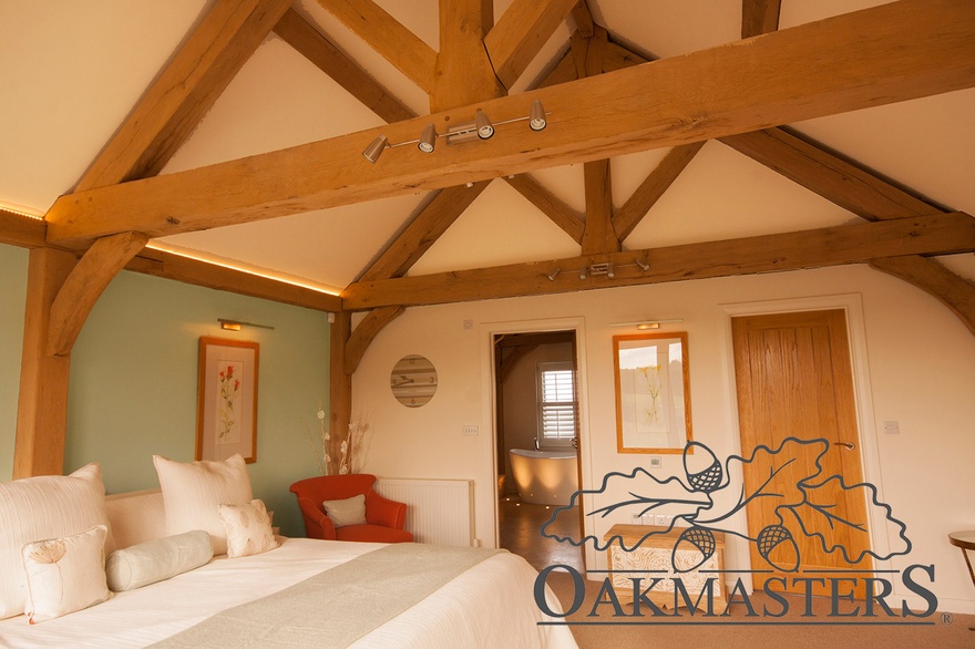 The master bedroom features lovely vaulted ceiling with exposed oak trusses