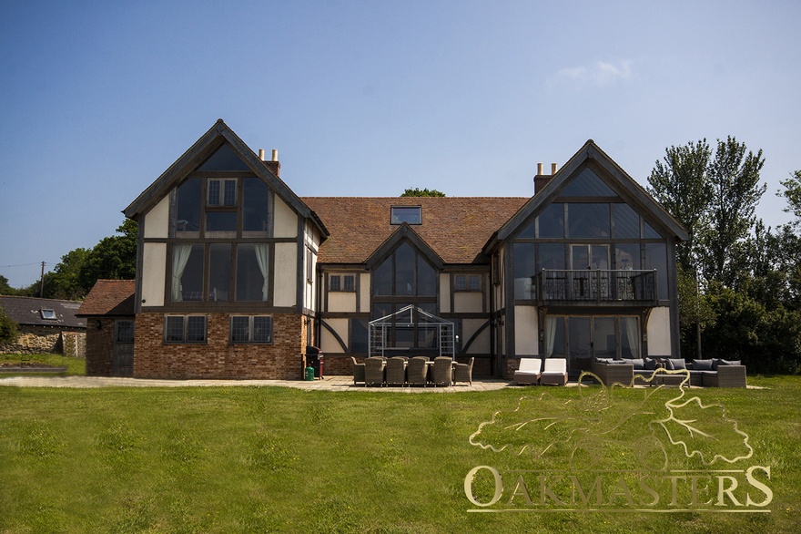 Rear of the oak framed house features large glazed sections to allow uninterrupted views