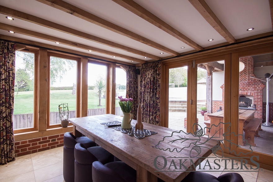 The dining space with oak ceiling beams is part of the open plan kitchen area
