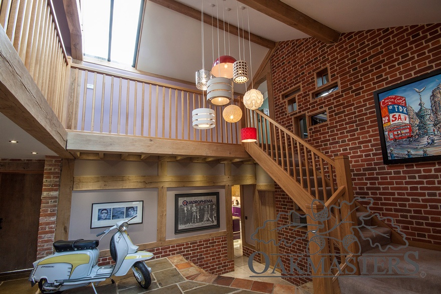 Double height entrance hallway features exposed oak beams and a lovely staircase and landing