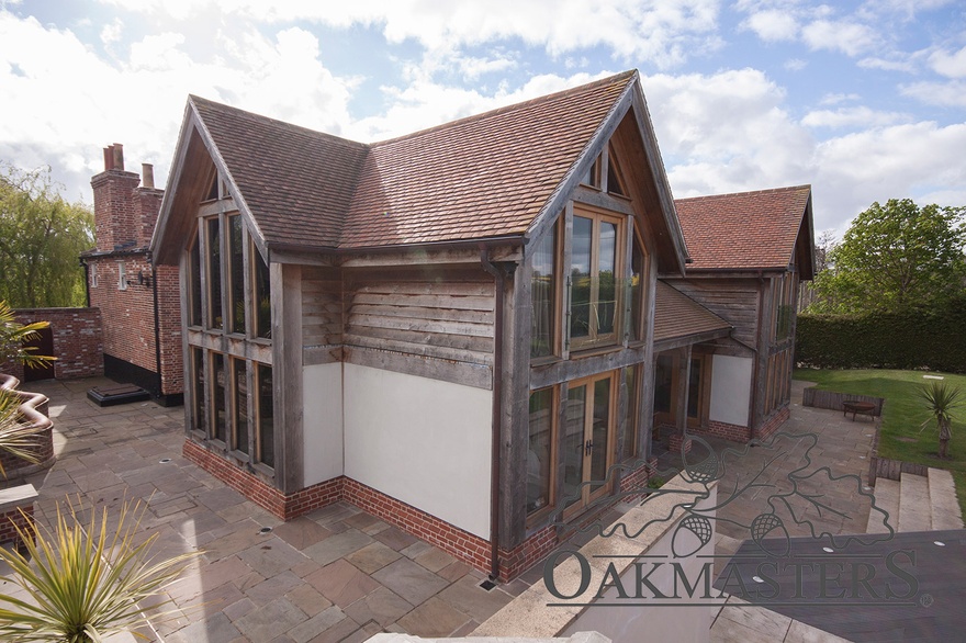 The oak framed extension features three glazed double height oak gables