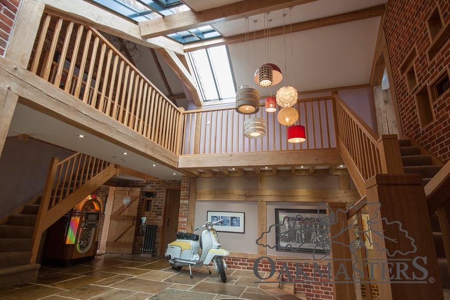 A partially glazed roof floods the oak framed hallway with natural light