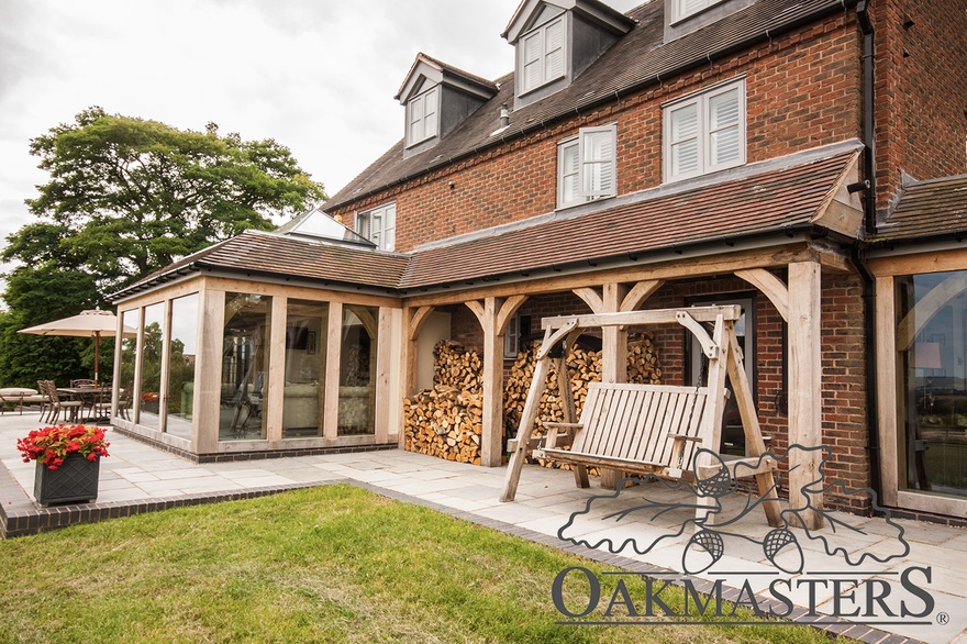 Large oak log store adds character to the rear of the house