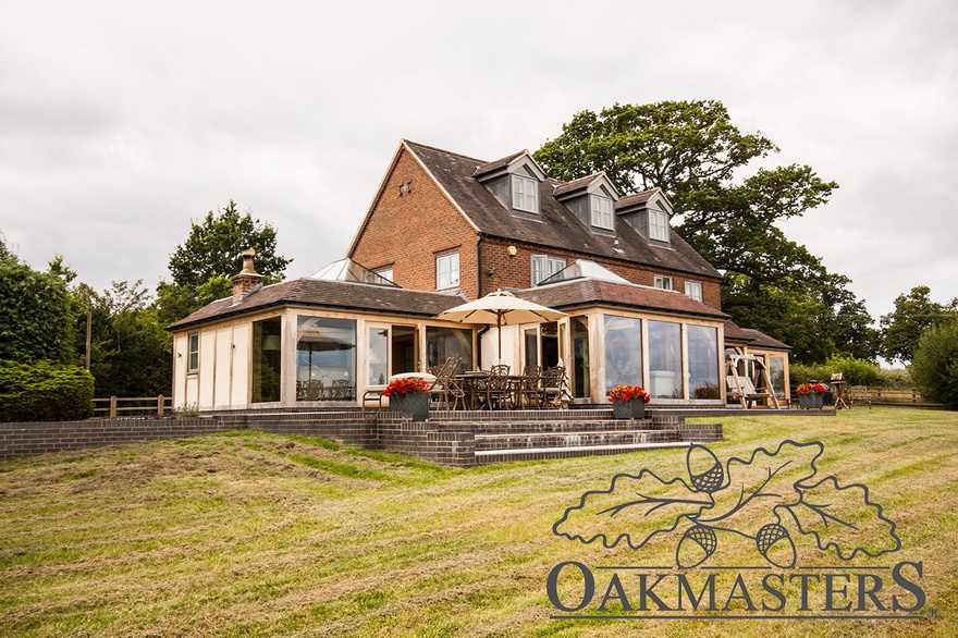The oak framed extensions have low roofs to allow views from upper floors across the countryside