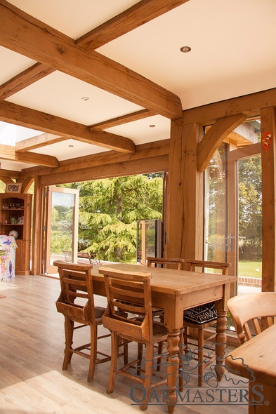 The flat ceiling of the oak orangery is broken up by oak beams and lanterns