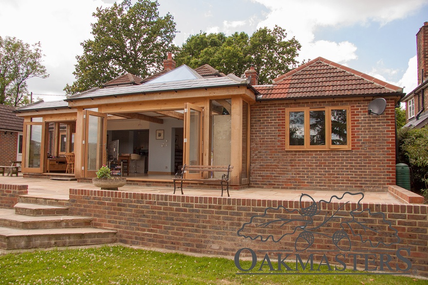 Oak bifold doors connect the oak extension with the outside