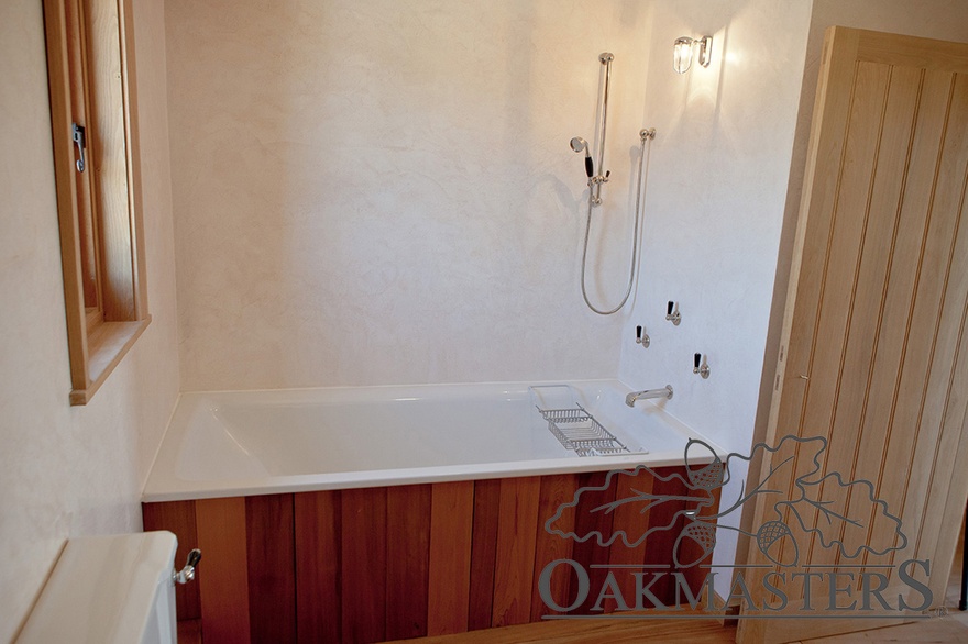 Oak and cedar combine beautifully in the small ensuite bathroom
