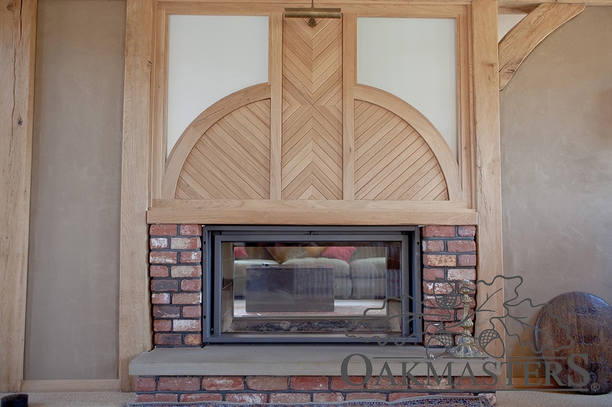 Structural oak frames a woodburning stove in the entrance hall