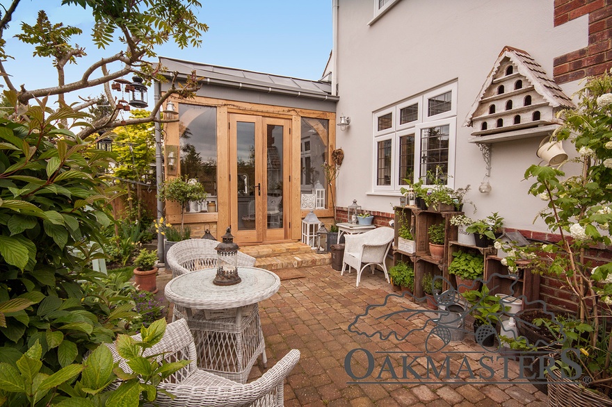Oak french doors open onto a cosy paved patio