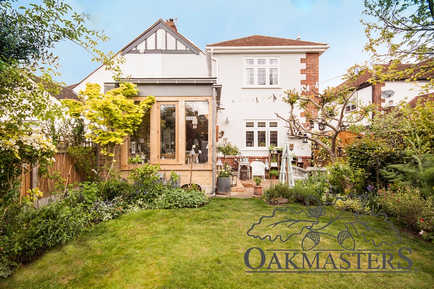 The oak extension has a very low pitch zinc roof to allow uninterrupted view from the upstairs windows