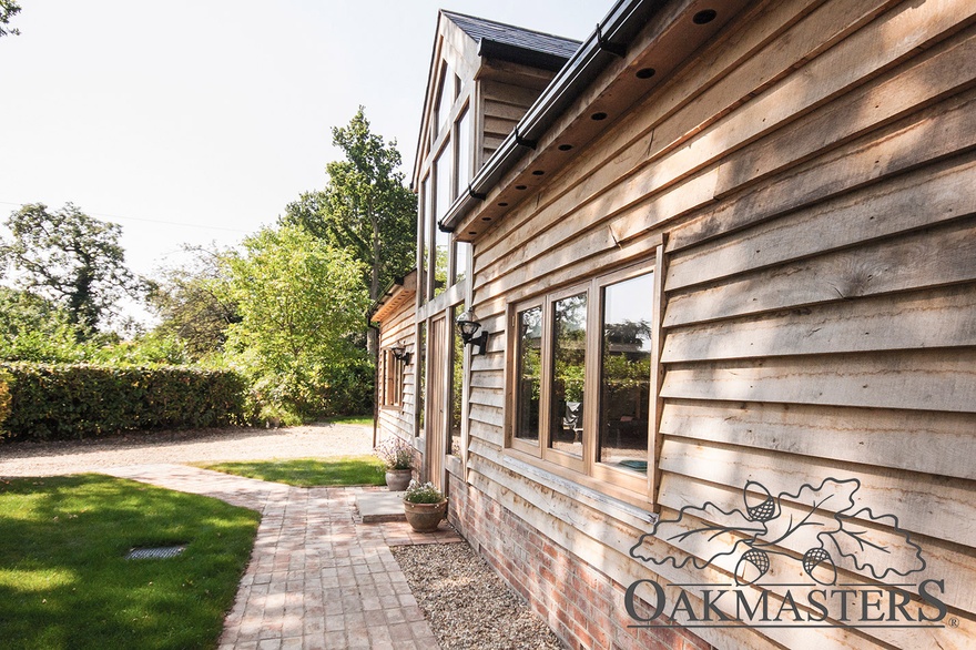 The self-build oak cottage is clad with featheredge cladding.