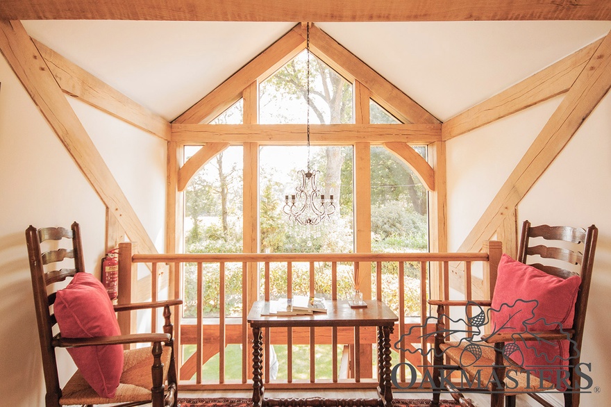 Upstairs, a gallery overlooks the glazed gable, offering a stunning view.