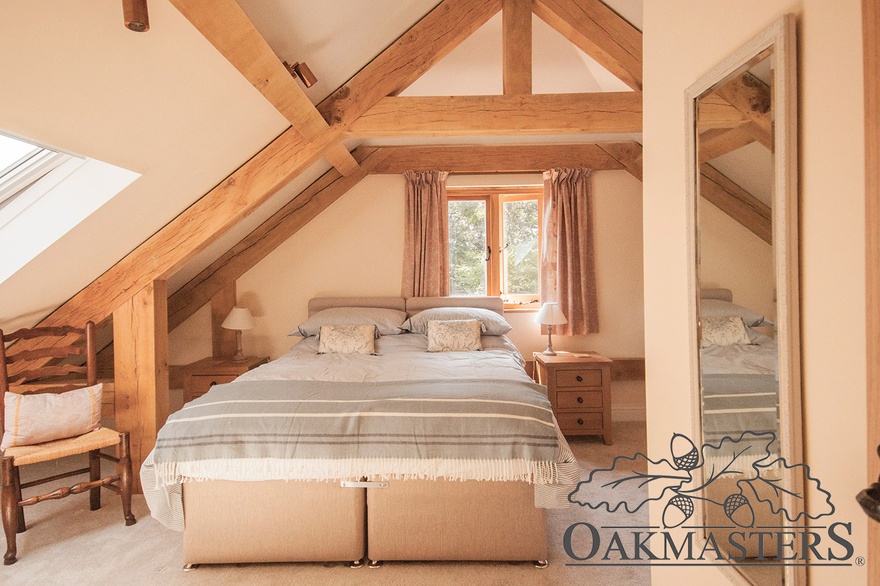 Upstairs, two bedrooms with raised collar oak trusses.