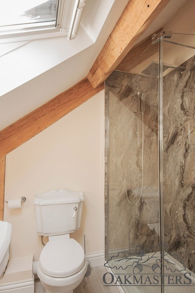 The upstairs en-suite shower rooms also feature oak beams.