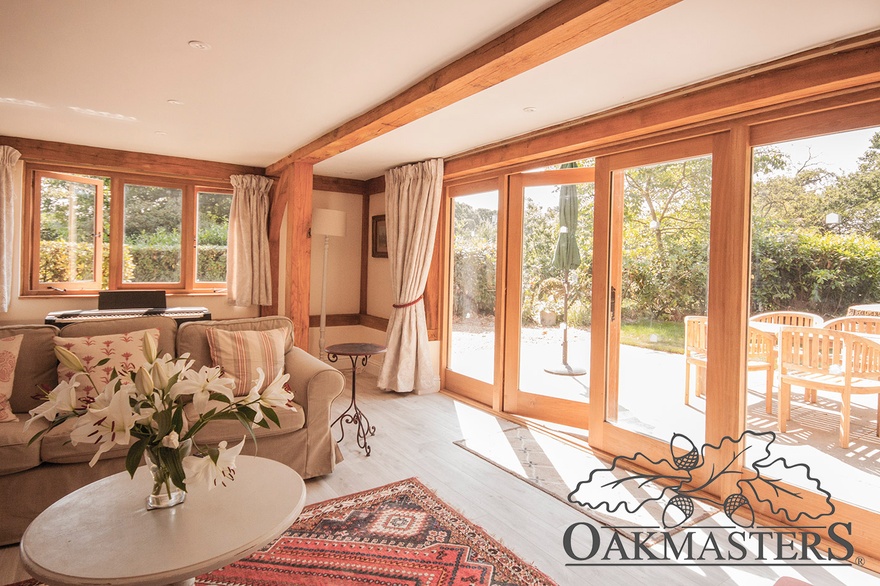 The side of the cottage opens up onto a patio with this lovely oak bifold door.