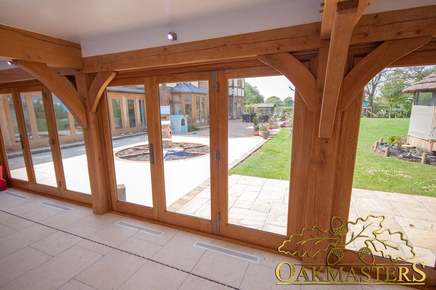 Oak bifold doors fitting snuggly into the oak frame