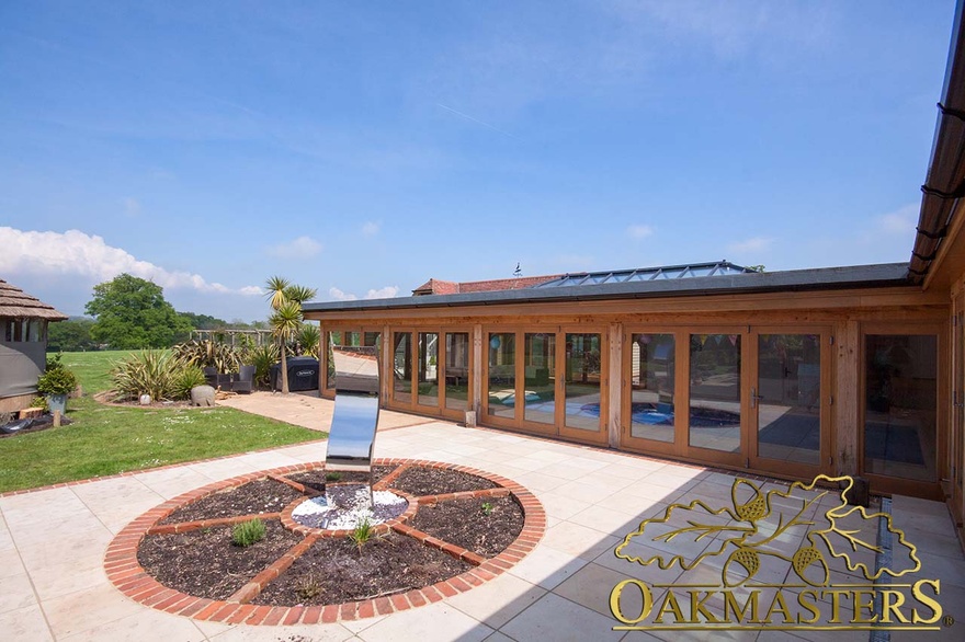 A pretty water feature adds charm to the oak framed pool building