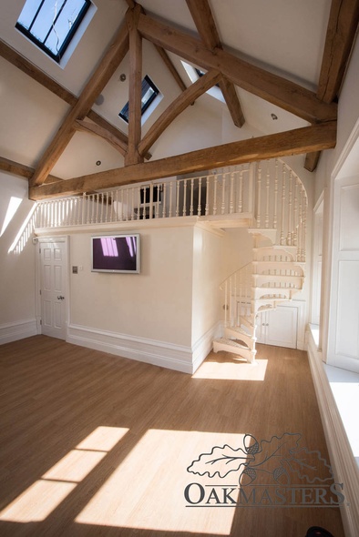 At the other end of the gym, a small office sits up in the oak roof