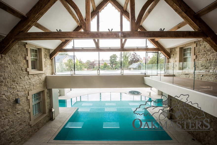 The view across the swimming pool and out through the glazed oak truss and wall is inspiring