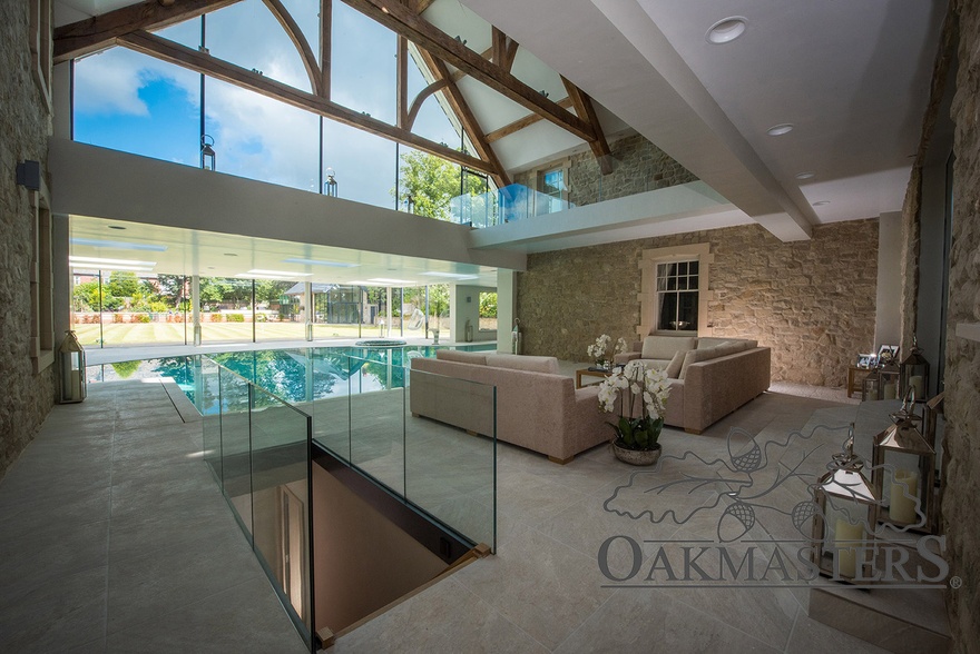 Luxury swimming pool building enhanced with a vaulted ceiling featuring structural oak trusses