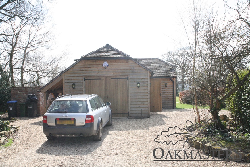 Oak framed garage with logstore on one end.