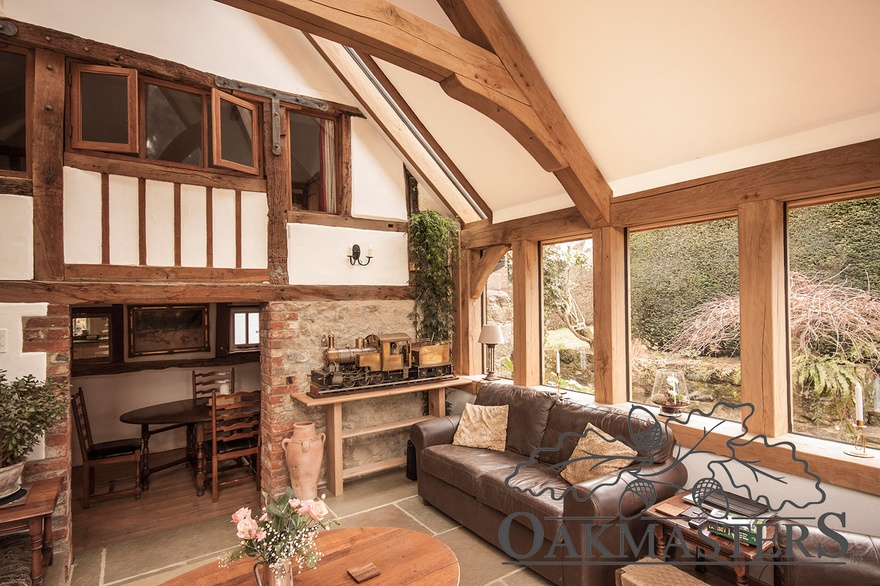 The oak roof on the new extension is clearly separated from the listed house with narrow glass panels