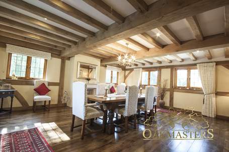 View from the entrance door towards the fireplace show off the oak beam layout in its full glory.