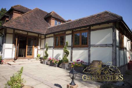 Outside is clad in reclaimed oak to match the existing house.