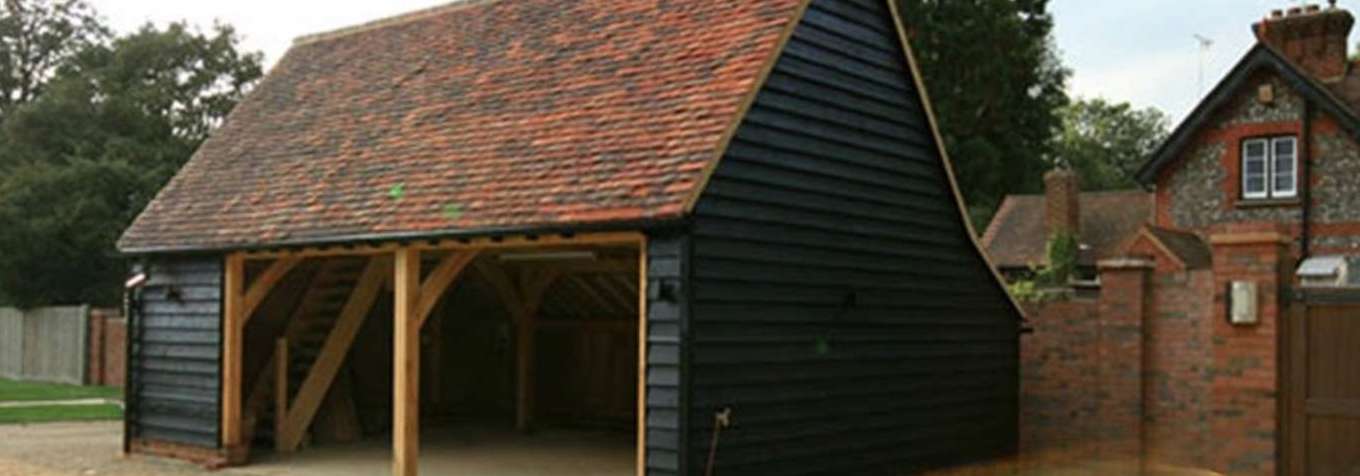 Bespoke oak-framed 2-bay open garage with internal stairs. This luxury design is made to order in the UK, using sustainable oak. 