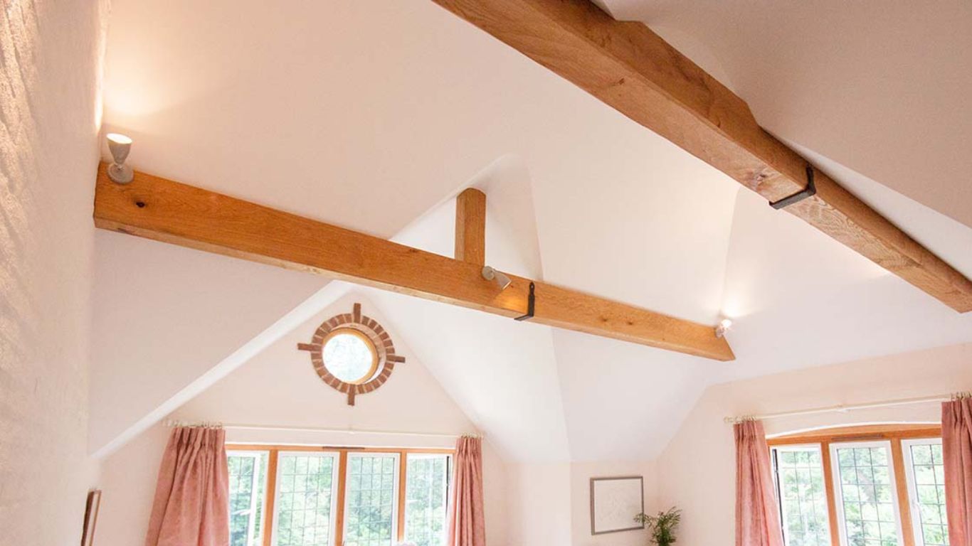 Four-sided oak beam covers conceal RSJ supports in the ceiling, adding to the character of the home.