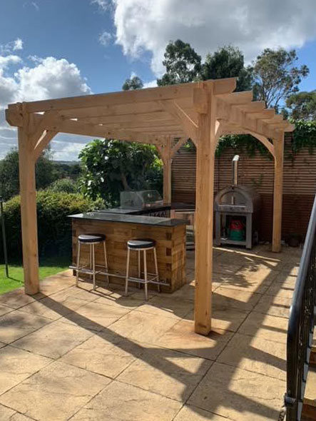 Sunny patio featuring oak pergola kit frame